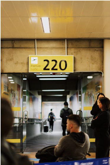 Travelers seated and waiting for boarding at an airport, symbolizing the anticipation of travel