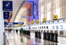 A busy airport terminal with travelers and luggage, symbolizing the start of an international journey.