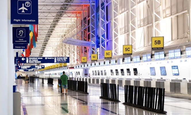 A busy airport terminal with travelers and luggage, symbolizing the start of an international journey.